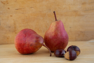 Two pears edible fruits, tasty ripened red yellow fruit on wooden background