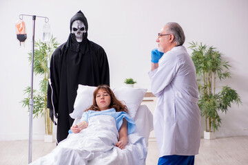 Devil, old doctor and female patient in the clinic