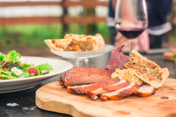 Delicious plate of chicken, quiche, salad and red wine