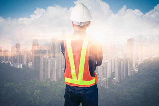 image of engineer standing in front of the city
