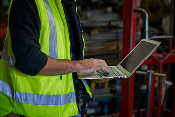 Engineer use laptop for check list in manufacture heavy industry