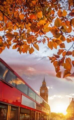 Fototapeten Big Ben against colorful sunset with red bus during autumn in London, England © Tomas Marek