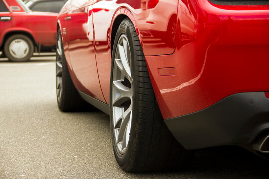 Kiev, Ukraine - April 21, 2020: Muscle car Dodge Challenger SRT8 392 HEMI in the parking lot. Red car. Car wheel