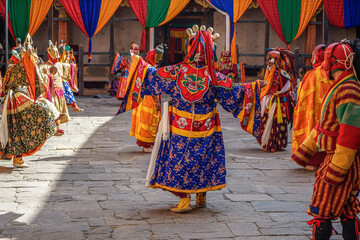 Bhutan,  in the village of Bumthang, a monk mask dancer in his colourful costume dances at the...