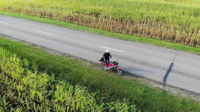 Motorcycle Riding By Country Road On Sunset, Beautiful Adventure Travel Footage Shot From Drone, Top Aerial