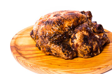 Roast chicken on a wooden tray on white background