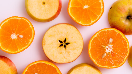Apple and orange slices on a white background,