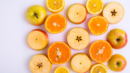 Apple and orange slices on a white background