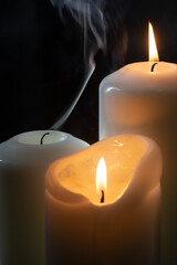 Lit candles with a smoke trail