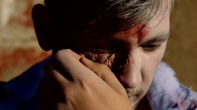 Slow motion. Zombie head close up. Portrait of scary bad zombie at night with bloody skin.