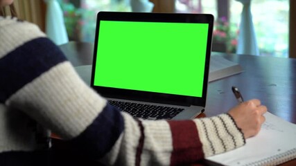 Teen girl school student by webcam conference call remote learning green screen laptop. Internet tutor teaching web class. E learning from home concept. Over shoulder close up laptop screen view. - Powered by Adobe