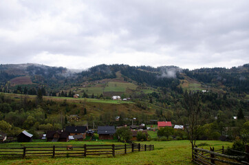Fototapeta premium Autumn landscape in the mountains with a fog. Carpathian Mountains, Ukraine.