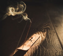 Smoking incense on wooden floor
