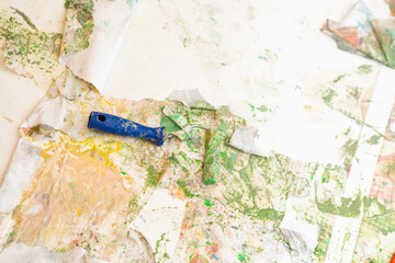 tools for painting the walls on white paper stained with paint