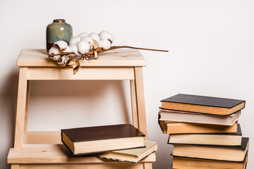 Still life home atmosphere in the interior with books and candles, home decor elements, comfort comfort, autumn winter seasonal weekend relaxation, stay at home self-isolation