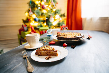 Cottages and gingerbread cookies on the Christmas table Gluten free christmas nut cake on a gray table with christmas decorations