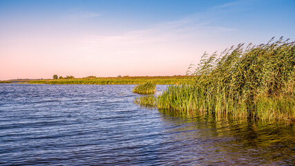 view of the quiet river with the beginning of the sunset