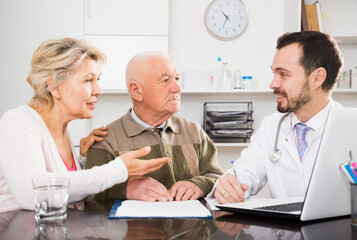 Old father with mature daughter visit doctor for consultation