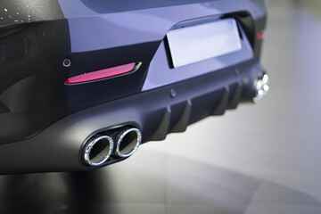 Close up of a car dual exhaust pipe in the sports car.