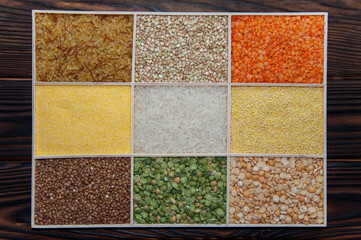 assorted different cereals in a box on a wooden surface