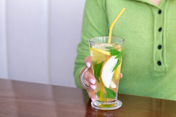 Woman drinking fruit tea in cafe
