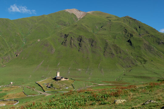 Bird eye view on Lamaria Church of the Virgin Mary in Ushguli community, located on a hill near Zhibiani village. Built in the 11 century and one of the most important historical monuments in Svaneti