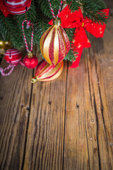 Christmas holiday background. Decorated christmas tree with traditional ball and toys, gift boxes over wooden background copy space