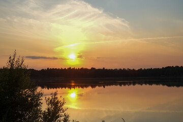 Dramatic and colorful sunset over a forest lake reflected in the water. Blakheide, Beerse, Belgium. High quality photo