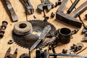 Variety of old vintage household hand tools still life on a wooden background in a DIY and repair concept