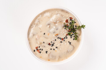 Mushroom cream soup in a white bowl, top view