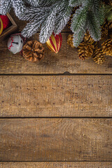 Christmas and New Year background for greeting card. Christmas flatlay with snowy fir tree branches  and xmas decoration wooden  board top view copy space frame