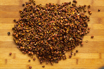 Cedar nut kernels, cedar nut shells. Cedar nut on wooden background.