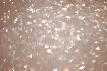 An abstract silver background with sparkle lights and bokeh.