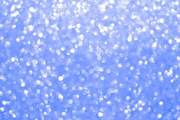 An abstract blue background with sparkle lights and bokeh.