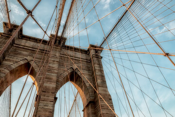 Supports of the Brooklyn Bridge. Geometry of the lines of support ropes and arches against a dramatic sky in New York, USA.