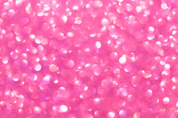 An abstract pink background with sparkle lights and bokeh. Pink blurred light.