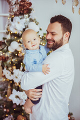 Happy young father with his sweet baby at christmas