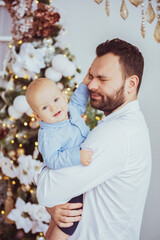 Happy young father with his sweet baby at christmas