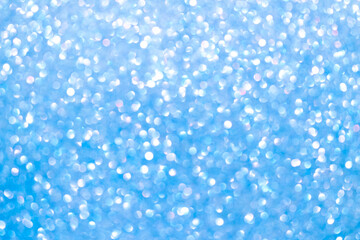 An abstract blue background with sparkle lights and bokeh.
