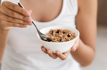 Closeup of plate with oatmeal in woman hands