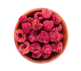 Dried raspberry isolated on white background. Dehydrated raspberry in wooden bowl. Top view.