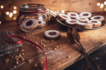 Homemade traditional linzer cookies
Homemade traditional linzer cookies with strawberry jam. Atmospheric christmas still life with golden bokeh and space for text.