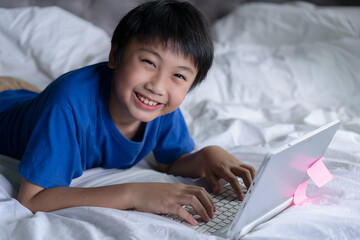 Fototapeta na wymiar Little boy using laptop learning for education online