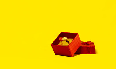 Vaccine box, ring box, pill, medicine for covid-19 coronavirus, dangerous flu, infection. Red holiday box with bow on yellow background