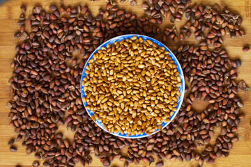Obraz premium Cedar nut kernels, cedar nut shells. Cedar nut on wooden background.
