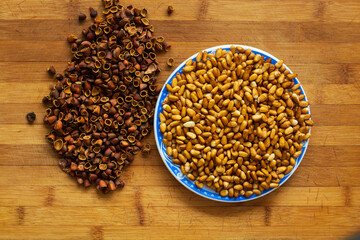 Cedar nut kernels, cedar nut shells. Cedar nut on wooden background.