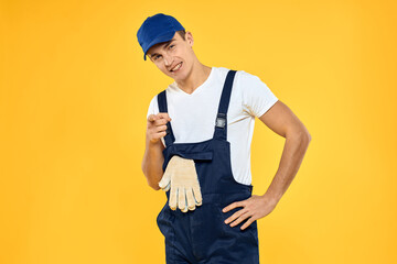 Man in working uniform emotions rendering service delivery service yellow background