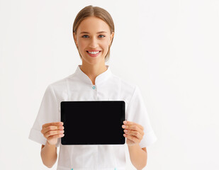 friendly doctor nurse with tablet wireless computer smiles in isolated against   white background