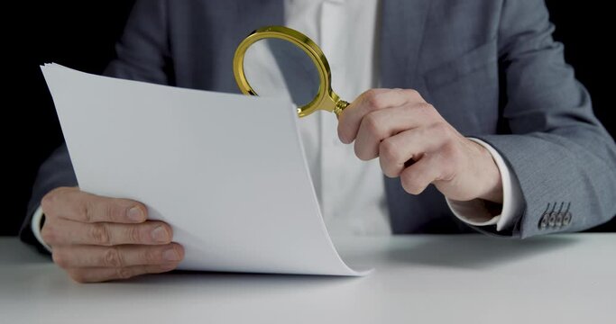 tax inspector investigating financial documents with magnifying glass. business audit and data analysis