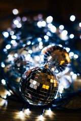 Silver disco ball Christmas decoration on dark background.